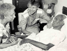 Family at the bedside of a person in hospice care